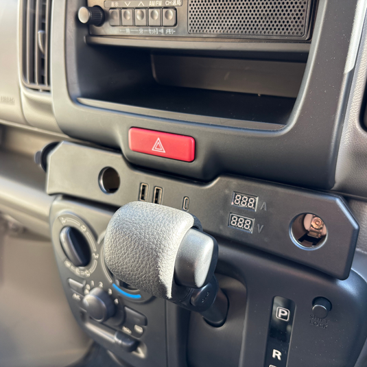 A Cigarette Lighter Extender for the Suzuki Every installed in the dashboard of a Suzuki Every
