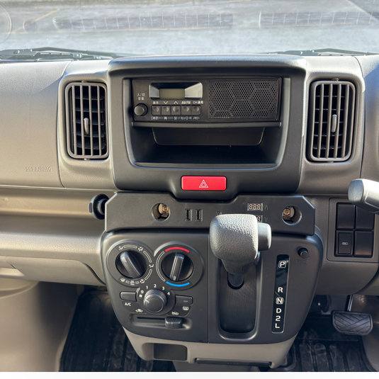 A Cigarette Lighter Extender for the Suzuki Every installed in the dashboard of a Suzuki Every