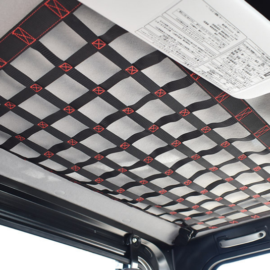 A black Hard Cargo Roof Net (standard size) attached to the roof of a Daihatsu Hijet