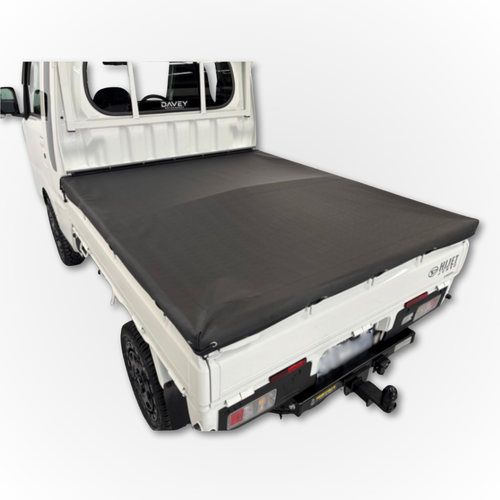 The Davey Motor Group Daihatsu Hijet Jumbo Tonneau Cover installed on a white Daihatsu Hijet Jumbo