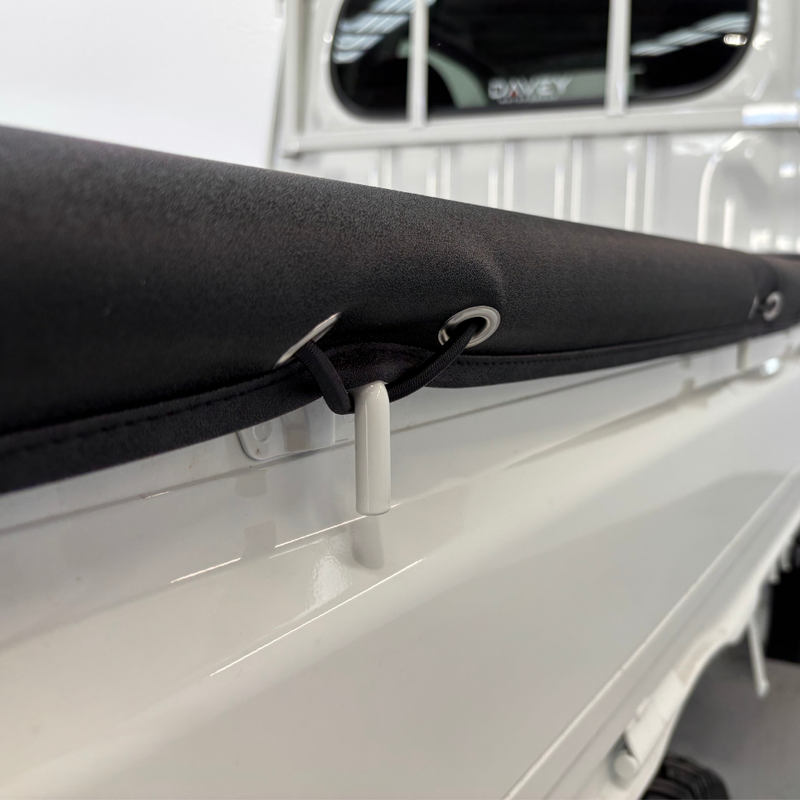 Load image into Gallery viewer, A close-up of the Davey Motor Group Daihatsu Hijet Jumbo Tonneau Cover installed on a white Daihatsu Hijet Jumbo
