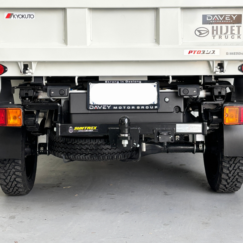 Load image into Gallery viewer, An installed Towbar sitting on the back of a cream Daihatsu Hijet
