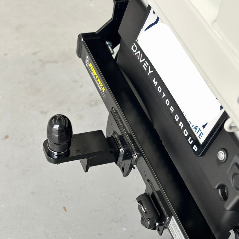 Load image into Gallery viewer, A close up from above of the Towbar installed on the back of a cream Daihatsu Hijet. 
