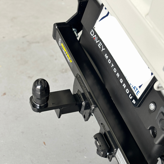 A close up from above of the Towbar installed on the back of a cream Daihatsu Hijet. 