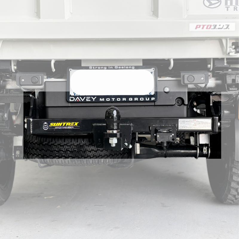 Load image into Gallery viewer, An installed Towbar sitting on the back of a cream Daihatsu Hijet. Focusing on the Towbar (blurring out surroundings)
