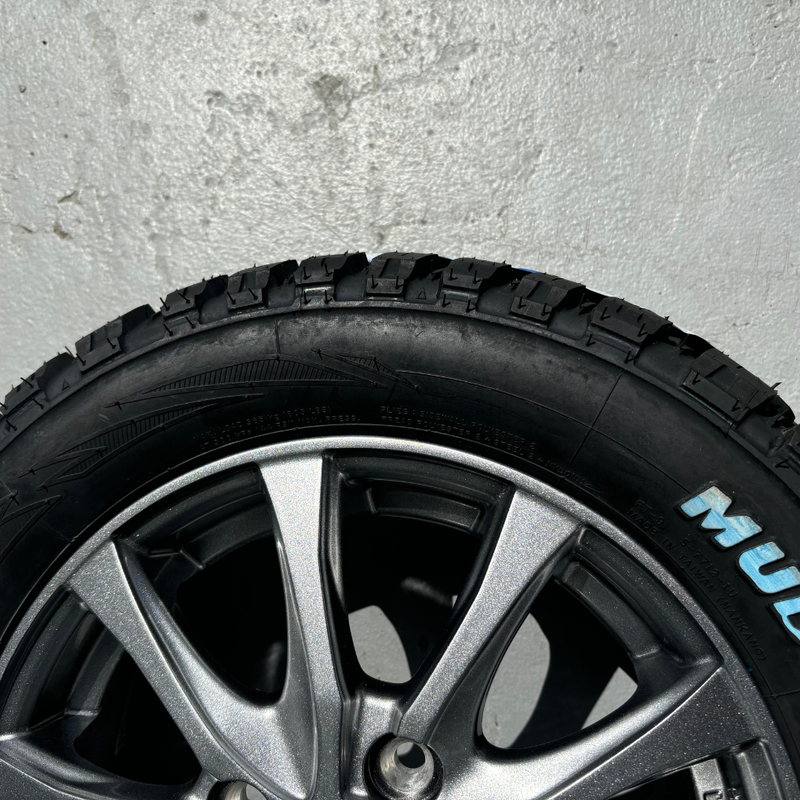 Load image into Gallery viewer, A close-up of the silver alloy wheel fitted to a Mudstar Radial tyre
